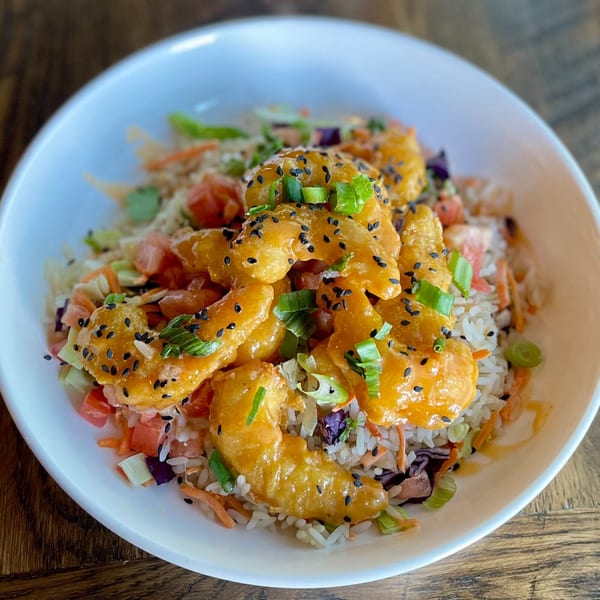 SouthTown PourHouse's crispy shrimp with orange sauce, sesame seeds, and green onions over rice.