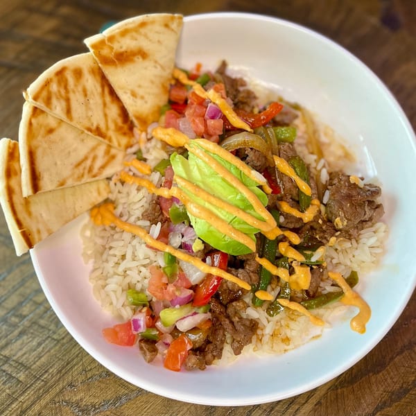 SouthTown PourHouse's steak and rice bowl with avocado, pico de gallo, and pita bread.
